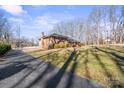 Side view of a brick ranch house and driveway at 220 Augusta Dr, Statesville, NC 28625