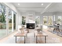 Bright living room featuring a fireplace, light wood floors, and sliding glass doors to the backyard at 2221 Edison St, Charlotte, NC 28206