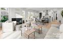 Bright living room featuring an open layout flowing to a kitchen, fireplace, and modern furniture at 2221 Edison St, Charlotte, NC 28206