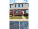 Tan and brick townhouse with red door and landscaping at 2705 N Center St # 65, Hickory, NC 28601