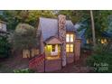 A charming two-story home with a stone fireplace and red stairs, illuminated at night at 27097 Cove Ln, Tega Cay, SC 29708
