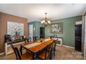 Formal dining room with a chandelier, stylish decor, and ample seating at 3028 Apple Orchard Pl, Dallas, NC 28034