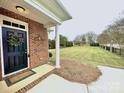 Dark-stained front door with wreath, inviting entry to the home at 4026 Saint James Way # 1, Monroe, NC 28110
