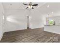 Spacious living room featuring hardwood floors, high ceilings, recessed lights, and large windows offering scenic views of the outdoors at 5177 Flay Rd, Lincolnton, NC 28021