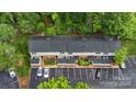 Aerial view of townhome community surrounded by lush trees with designated parking spots at 5929 Quail Hollow Rd # B, Charlotte, NC 28210
