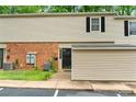 Exterior view of a townhome with siding, small front yard, and a parking spot at 5929 Quail Hollow Rd # B, Charlotte, NC 28210
