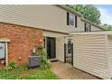 Townhome exterior with brick and vinyl siding, gated patio, and well-maintained landscaping at 5929 Quail Hollow Rd # B, Charlotte, NC 28210
