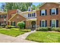 Charming brick home with a green lawn and manicured bushes on a sunny day at 9108 Nolley Ct # B, Charlotte, NC 28270