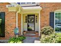Inviting front porch featuring a decorative door, potted plants, and a welcome sign at 9108 Nolley Ct # B, Charlotte, NC 28270