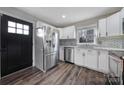 Modern kitchen featuring stainless steel appliances, white cabinets, and stylish backsplash at 1019 Palmyra Dr, Tega Cay, SC 29708