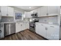 Well-lit kitchen with stainless steel appliances, bright white cabinetry, and modern fixtures at 1019 Palmyra Dr, Tega Cay, SC 29708