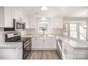 Bright, newly renovated kitchen with white cabinets, stainless steel appliances and light-colored counters at 10718 Downpatrick Pl, Charlotte, NC 28262