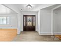 Bright entryway with hardwood floors and a dark brown door at 115 E Texas Ave, Bessemer City, NC 28016