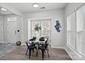 Bright dining area features modern decor, a stylish table setting, and plenty of natural light at 141 N Arcadian Way, Mooresville, NC 28117