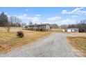 Gray mobile home with wrap-around porch and detached garage at 15918 Big Bear Rd, Albemarle, NC 28001