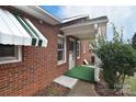 Brick house detail showing a covered entry and green door at 1648 Newton Dr, Statesville, NC 28677