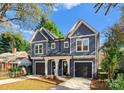 Beautiful two-story duplex with individual garages and manicured lawns at 2149 Highland St, Charlotte, NC 28208