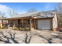 Single-story home featuring a covered porch, attached garage and neatly landscaped yard at 236 Ervin Rd, Mooresville, NC 28117