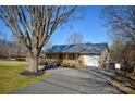 Inviting home boasting a spacious driveway, attached garage, and delightful front porch at 236 Ervin Rd, Mooresville, NC 28117