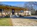 Lovely home showcasing a welcoming front porch, brick paver walkway and manicured landscaping at 236 Ervin Rd, Mooresville, NC 28117