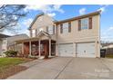 Charming two-story home with a welcoming front porch and a two-car attached garage at 2415 Impatien Dr, Charlotte, NC 28215