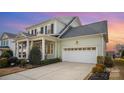 Green two-story house with white trim, a large garage, and landscaping at 328 Sensibility Cir, Fort Mill, SC 29708