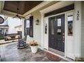 Front porch with a rocking chair, swing, and decorative planters at 328 Sensibility Cir, Fort Mill, SC 29708