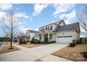 Lovely neighborhood street view showcasing well-kept homes with manicured lawns and sidewalks at 328 Sensibility Cir, Fort Mill, SC 29708