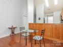 Cozy dining area with hardwood floors and a modern glass-top table with stylish chairs at 3867 Azalea Trl, Denver, NC 28037