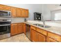 Well-equipped kitchen with stainless steel appliances, granite countertops, and wood cabinets at 3867 Azalea Trl, Denver, NC 28037