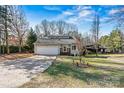 Attractive home exterior featuring a well-manicured lawn, charming front entrance, and driveway at 3995 Burton Ln, Denver, NC 28037