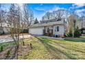 Beautiful home exterior showcasing the garage, well-maintained lawn, and charming front entrance at 3995 Burton Ln, Denver, NC 28037