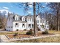 White brick home with landscaping and a three-car garage at 4001 Carmel Acres Dr, Charlotte, NC 28226