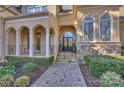 Elegant home entrance featuring a paved walkway and a stylish arched doorway at 4004 Blossom Hill Dr, Matthews, NC 28104