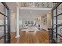 Bright and airy living room with hardwood floors, a fireplace, and large windows at 4004 Blossom Hill Dr, Matthews, NC 28104