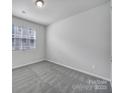 Well-lit bedroom with neutral carpet and a window offering natural light at 432 Burr St, Indian Trail, NC 28079