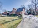 Brick home with a long driveway and attached garage at 6020 Havencrest Nw Ct, Concord, NC 28027