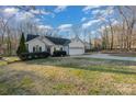 Traditional one-story home featuring a well-maintained lawn and attached two-car garage at 781 Woodlawn Ave, Mount Holly, NC 28120