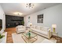 Cozy living room with a brick fireplace, plush rug, and comfortable seating at 8025 Cliffside Dr, Charlotte, NC 28270