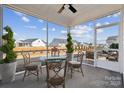 A screened-in patio shows an outdoor dining set for four and plenty of space for entertaining at 8348 Acadia Pkwy, Sherrills Ford, NC 28673