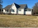 This is the exterior of a classic home with a sunroom and a neatly landscaped yard at 897 Mocksville Hwy, Statesville, NC 28625