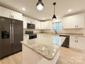 Bright kitchen with stainless steel appliances, granite counters, and central island at 1006 Scout Cabin Rd, Kershaw, SC 29067