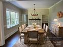 Dining room with a large wooden table, chandelier, and hardwood floors at 105 N Inman Ave, Bessemer City, NC 28016