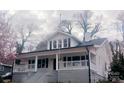 Inviting two-story home featuring a charming covered porch, perfect for enjoying the outdoors in comfort and style at 105 N Inman Ave, Bessemer City, NC 28016