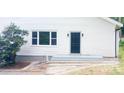 Image of the home's front door with white siding and a well-maintained landscaped front yard at 105 N Inman Ave, Bessemer City, NC 28016