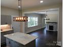 An open-concept kitchen with gray cabinets and a marble island at 105 N Inman Ave, Bessemer City, NC 28016