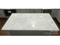 Close-up of the kitchen island featuring a countertop with black speckled detail at 105 N Inman Ave, Bessemer City, NC 28016