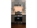 New stainless steel oven, exhaust hood, and cabinets in a newly renovated kitchen at 105 N Inman Ave, Bessemer City, NC 28016