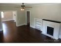 Cozy living room featuring hardwood floors and a fireplace with built in shelves at 105 N Inman Ave, Bessemer City, NC 28016