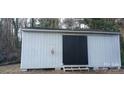 Image of storage shed with black door and wooden steps with 'For Sale' canopy ad at 105 N Inman Ave, Bessemer City, NC 28016